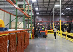 Operator being supervised by a trainer during a forklift certification course.